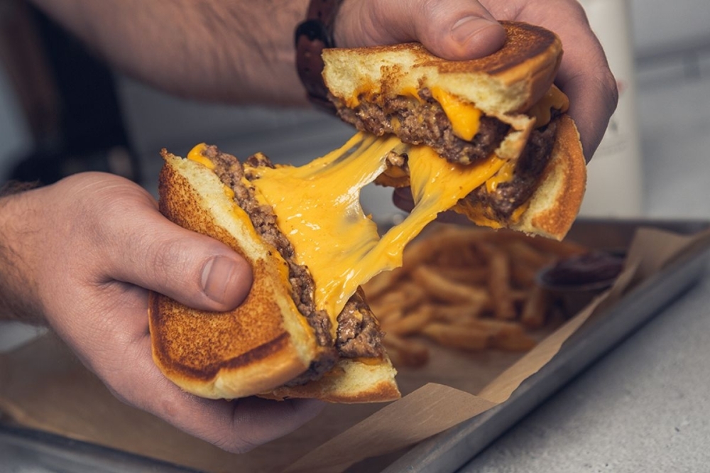 Wayback Burgers' menu features a cheesy melt burger with two beef patties and four slices of American cheese. (Courtesy Wayback Burgers)