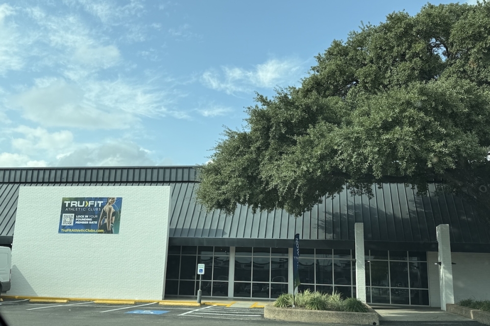 The exterior of a gym getting ready to open to the public.