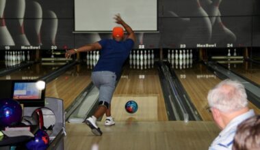 a person rolls a bowling ball down a bowling lane
