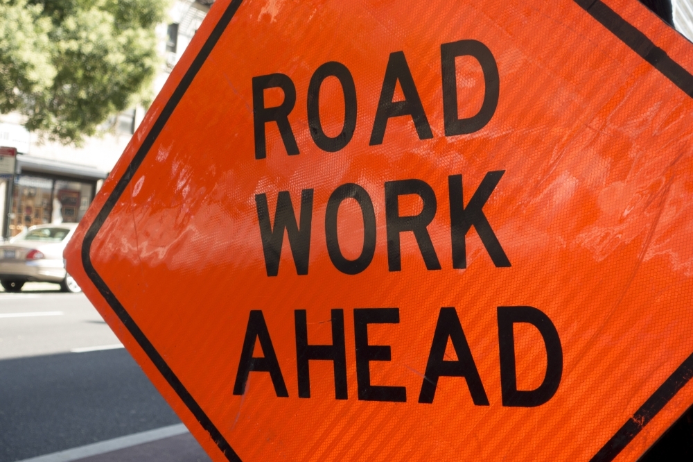 orange road work ahead sign