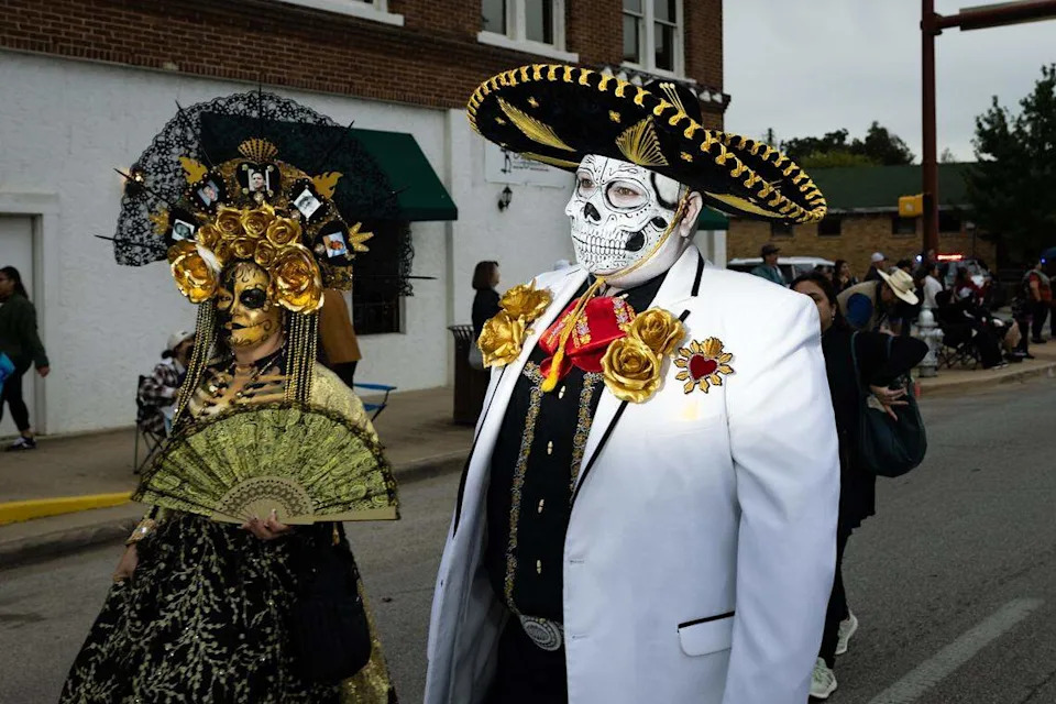 Parade participants walk down Main Street for the Día De Los Muertos Parade in Northside Fort Worth on Saturday, Nov. 1, 2025.