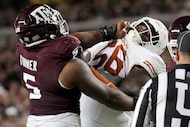 Texas A&M defensive lineman Shemar Turner (5) and Texas offensive lineman Cameron Williams...