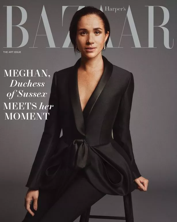 Meghan on the cover in a black suit