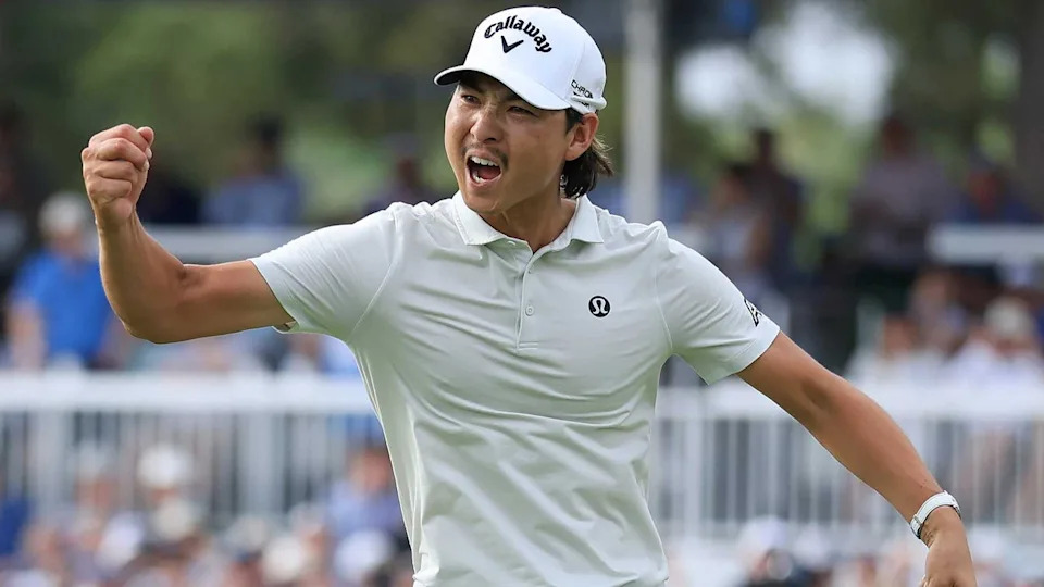min woo lee fist pumps at the Houston Open in gray shirt and white hat