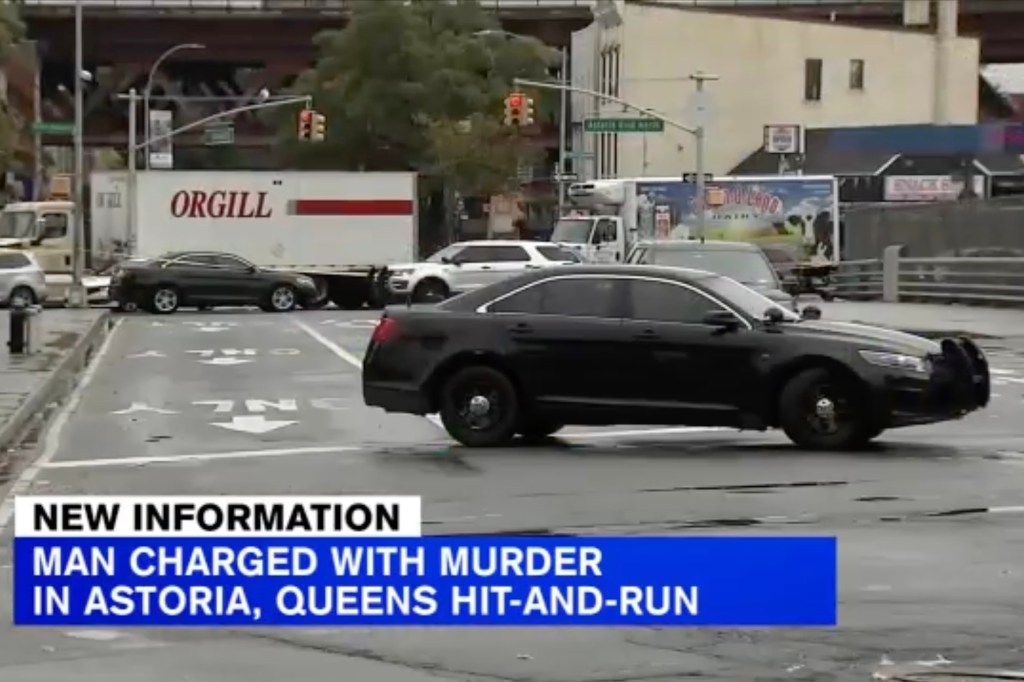 A police vehicle on a city street, with an "ORGILL" truck and news text overlay "MAN CHARGED WITH MURDER IN ASTORIA, QUEENS HIT-AND-RUN."