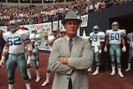 Dallas Cowboys coach Tom Landry waits at the tunnel entrance with the players before a game...
