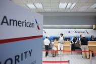 Passengers check in at the kiosk of American Airlines, on Friday, Nov. 7, 2025, at Dallas...