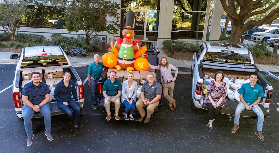 The 2024 turkey drive team of Russell Rowland Inc., a Jacksonville structural engineering firm, poses with some of the 506 turkeys they collected for needy families' Thanksgiving tables. This year they hope to collect 600.