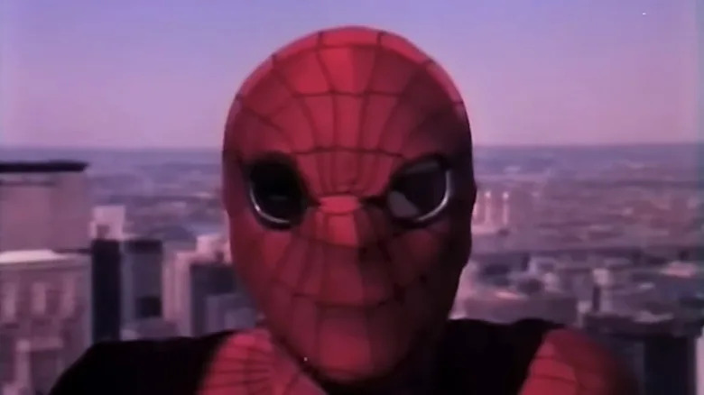 Nicholas Hammond as Spider-Man looks at the camera with a cityscape visible in the background in The Amazing Spider-Man