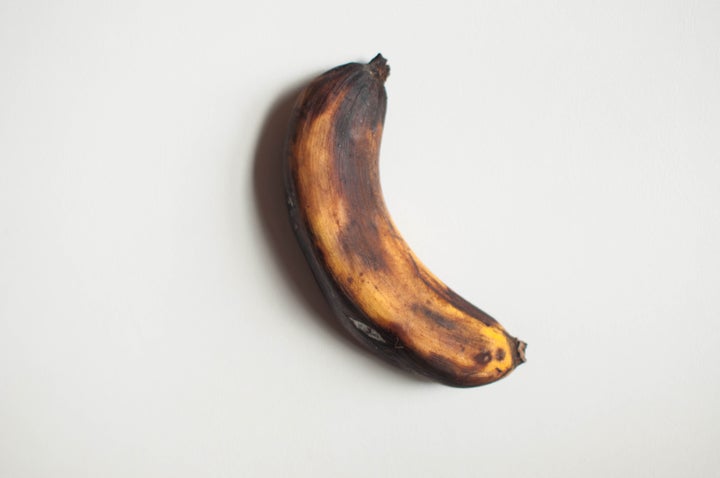 An overripe banana looks brown or black and is usually mushy.