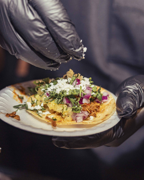 LA PINA FUEGO_Slow roasted pork infused with bright citrus flavors, topped with queso fresco and grilled pineapple pico, wrapped in warm corn tortillas.