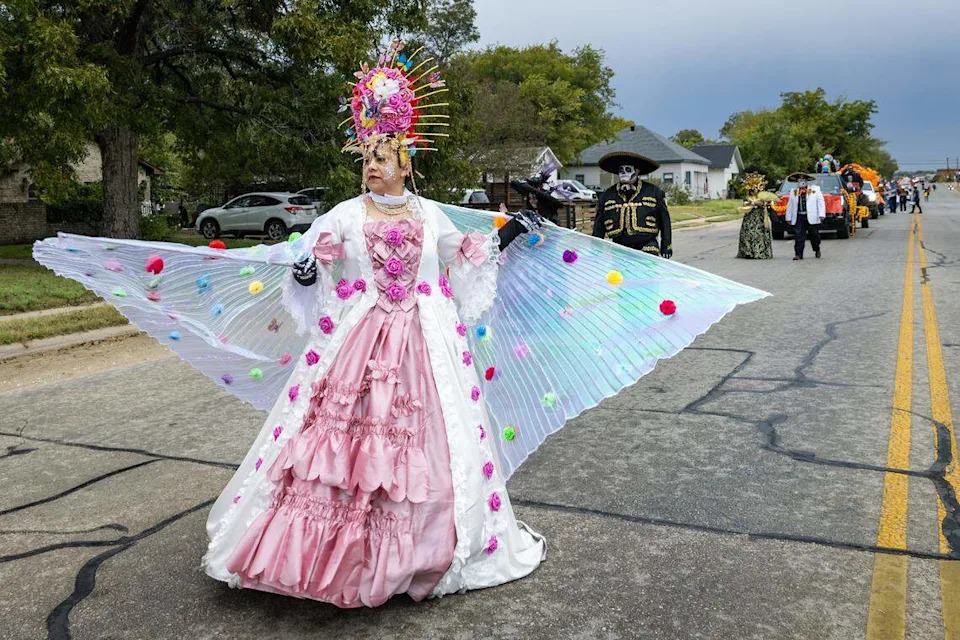 Parade participants walk down Ellis Avenue for the Día De Los Muertos Parade in Northside Fort Worth on Saturday, Nov. 1, 2025.