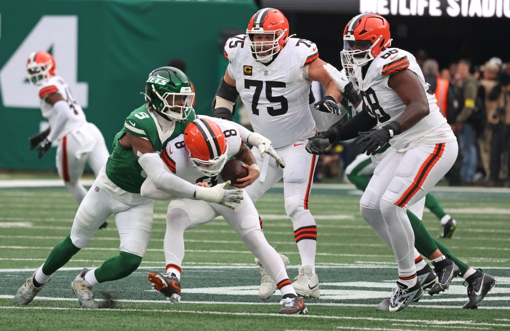 Will McDonald IV #9 of the New York Jets sacks Dillon Gabriel #8 of the Cleveland Browns.