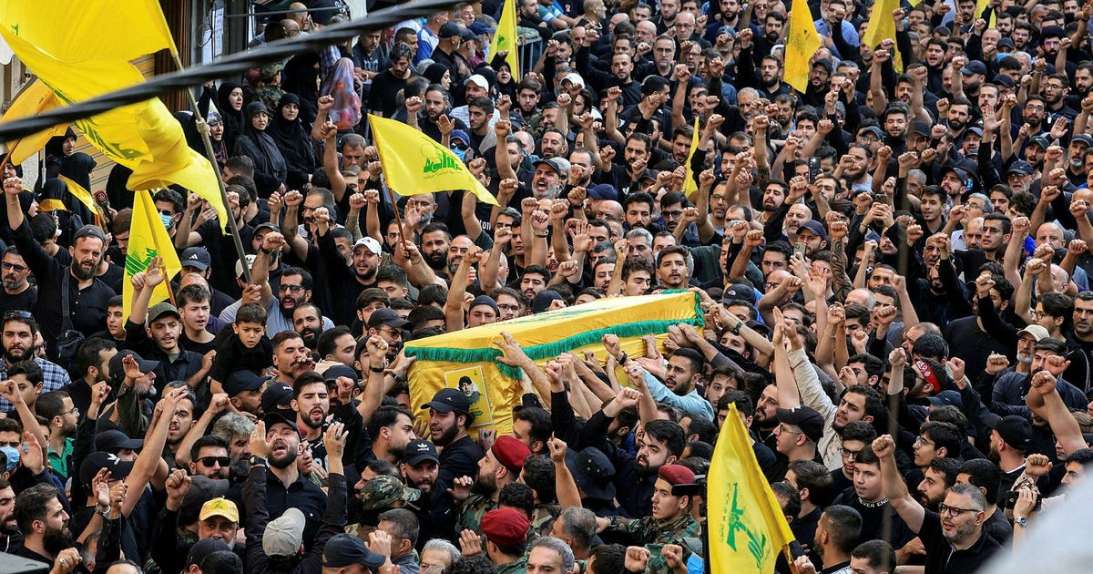 'We'll never surrender our weapons': Thousands mourn Hezbollah commander killed by Israel - Haaretz