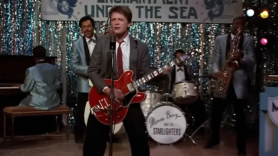 Michael J.  Fox playing the red Gibson guitar with the band in Back to the Future