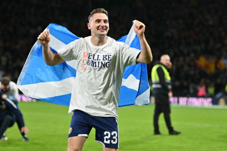 Scotland's midfielder #23 Kenny McLean celebrates on the pitch after the FIFA World Cup 2026 European qualification football match between Scotland and Denmark at Hampden Park in Glasgow on November 18, 2025. Scotland scored two dramatic stoppage-time goals to beat 10-man Denmark 4-2 on Tuesday and reach the World Cup for the first time since 1998. (Photo by ANDY BUCHANAN / AFP)