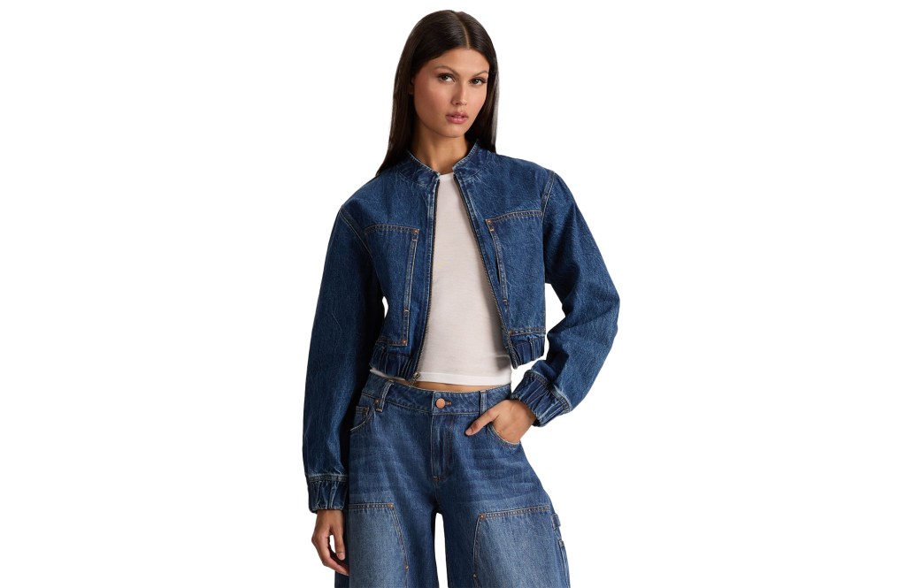 Woman wearing a dark denim jacket and matching jeans.