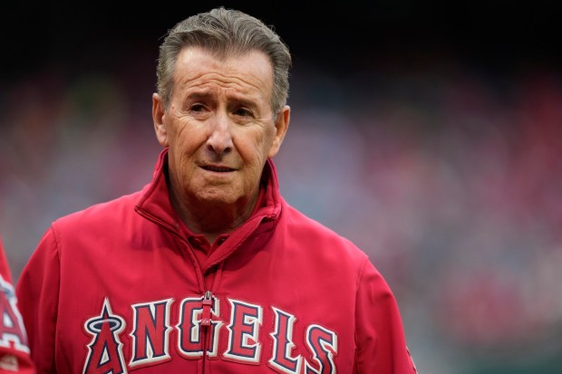 Arte Moreno, owner of the Angels, stands on the field before a game May 24, 2023. Moreno said Wednesday that he expects to be the Angels owner for the long run. (AP Photo/Ashley Landis)