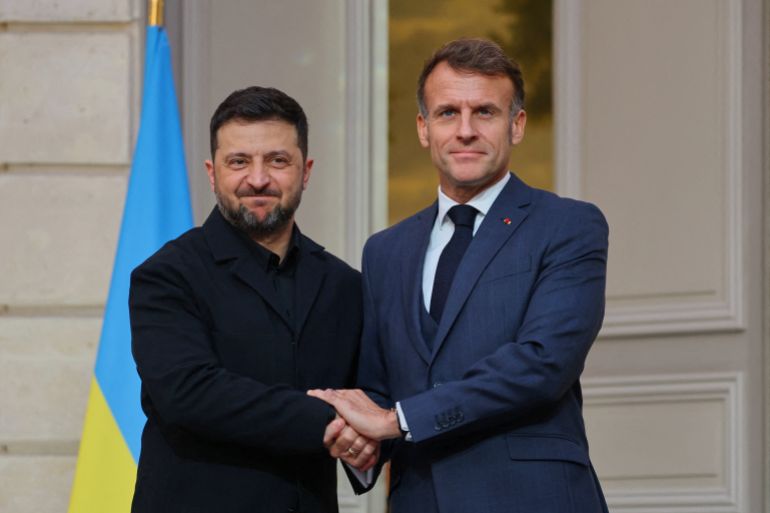 Ukrainian President Volodymyr Zelenskyy, left, and French President Emmanuel Macron shake hands after a joint media conference at the Elysee Palace in Paris on November 17, 2025. 