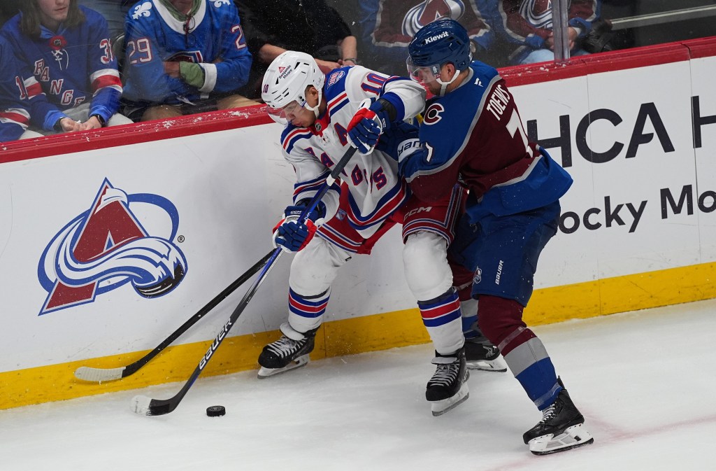 Artemi Panarin struggles to control the puck as he battles Devon Toews for possession during the Rangers' 6-3 loss to the Avalanche on Nov. 20, 2025 in Denver.