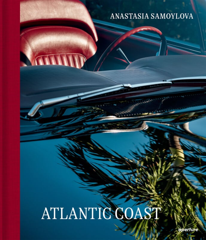A book cover with a red car interior and palm tree reflections on the windshield. Title: "ATLANTIC COAST." Author: "ANASTASIA SAMOYLOVA." The publisher's logo, "aperture," appears in the corner.