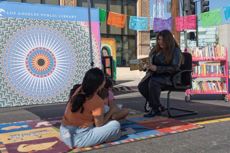 Maria Valenzuela, daughter of Dodgers legend Fernando Valenzuela, reads a book to children