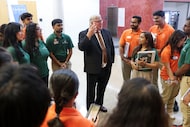 Richard Benson, the outgoing University of Texas at Dallas president, interacts with student...