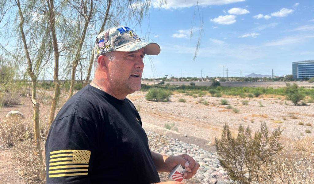 a man in a hat in a desert landscape