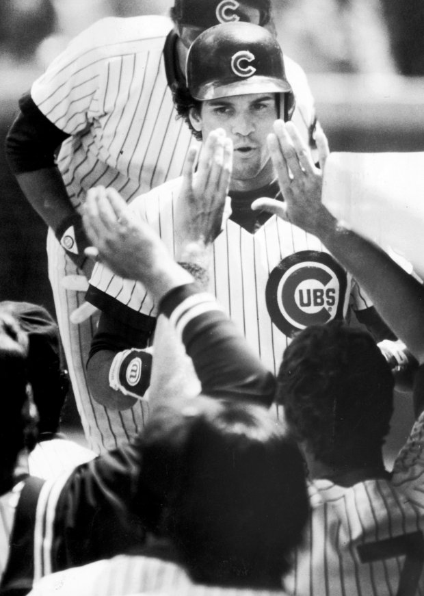 Teammates greet Ryne Sandberg after he tripled and scored in the third inning on June 24, 1984. (Jose Moré/Chicago Tribune)