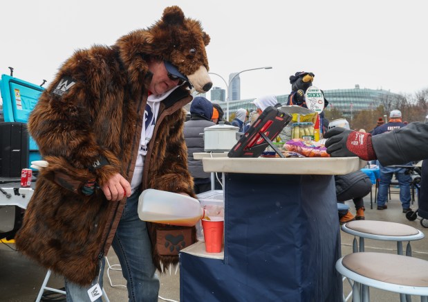 Chris Hughes of Elkhart, Ind., mixes a drink while tailgating before a Bears-Giants game Sunday, Nov. 9, 2025, at Soldier Field. (Dominic Di Palermo/Chicago Tribune)