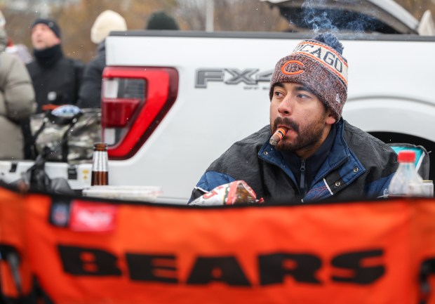 Xavier Medina of Tinley Park smokes a cigar while tailgating before a Bears-Giants game Sunday, Nov. 9, 2025, at Soldier Field. (Dominic Di Palermo/Chicago Tribune)