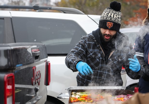 Chris Quinones of La Grange grills vegetables while tailgating before a Bears-Giants game Sunday, Nov. 9, 2025, at Soldier Field. (Dominic Di Palermo/Chicago Tribune)