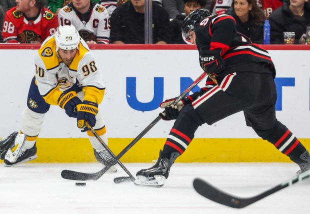 Nashville Predators center Ryan O'Reilly (90) and Blackhawks center Frank Nazar (91) battle for the puck during the second period, Nov. 28, 2025, at the United Center. (Dominic Di Palermo/Chicago Tribune)