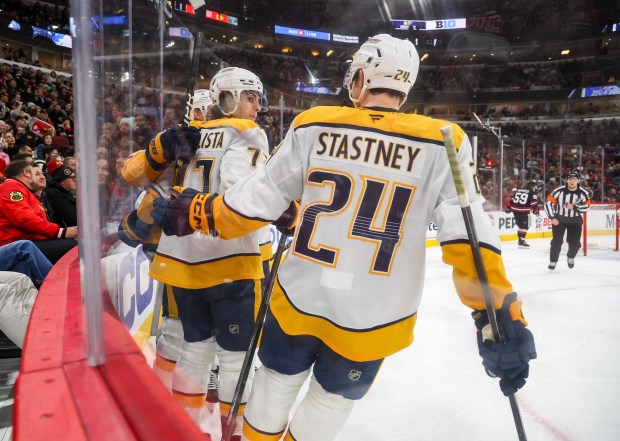 Nashville Predators center Steven Stamkos (91) and right wing Luke Evangelista (77) and defenseman Spencer Stastney (24) celebrate Stamkos' goal that brought the Predators to 2-1 during the second period against the Blackhawks, Nov. 28, 2025, at the United Center. (Dominic Di Palermo/Chicago Tribune)