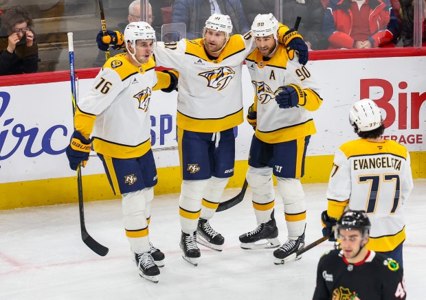 Nashville Predators defenseman Brady Skjei (76) and center Steven Stamkos (91) celebrate center Ryan O'Reilly's (90) goal that extended the Predators' lead 4-2 during the third period against the Blackhawks, Nov. 28, 2025, at the United Center. (Dominic Di Palermo/Chicago Tribune)