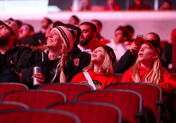 Fans smile while watching a video on the scoreboard before a game between the Chicago Blackhawks and the Nashville Predators, Nov. 28, 2025, at the United Center. (Dominic Di Palermo/Chicago Tribune)