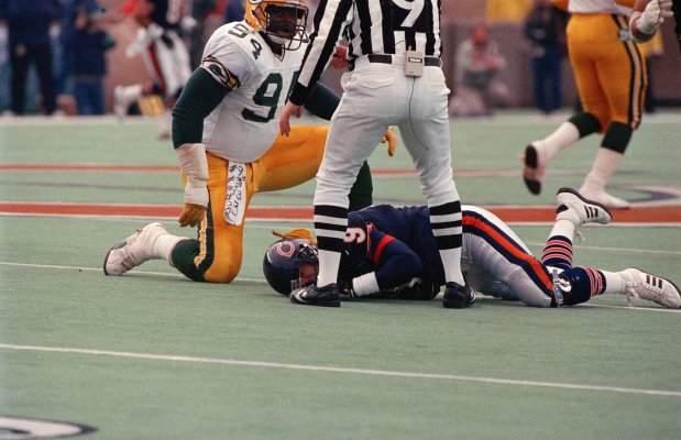 Green Bay Packer Charles Martin (94) gets up after slamming Chicago Bears quarterback Jim McMahon to the ground during a game on Nov. 23, 1986, at Soldier Field in Chicago. The play occurred after a Packer interception in the second quarter. Referee Jerry Markbreit (9), who witnessed the act from a few feet away, assessed a 15-yard penalty and ejected Martin. (Edward Wagner/Chicago Tribune)