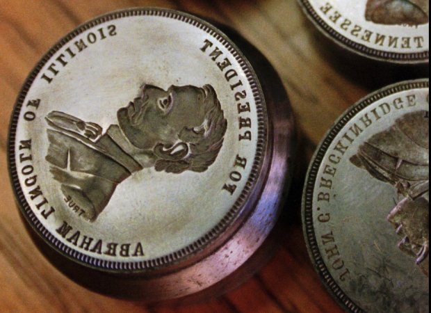 Abraham Lincoln had Osborne Coinage Co. make this coin die in 1864 for his second presidential campaign. The die is shown on Jan. 29, 1997, in Cincinnati. The lettering is reversed because a die produces a positive image when the coin is stamped out of the press. (Al Behrman/AP)
