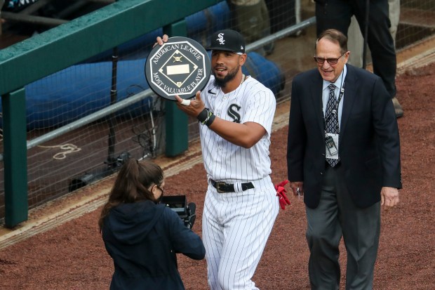 Chicago White Sox first baseman Jose Abreu holds up his 2020 American League MVP award before the first inning of the home opener against the Kansas City Royals at Guaranteed Rate Field on April 8, 2021, in Chicago. (Armando L. Sanchez/Chicago Tribune)