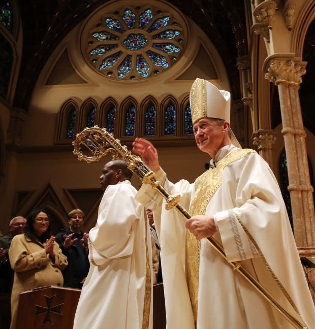 Archbishop Blase Cupich, right, leaves the altar after his elevation ceremony on Nov. 18, 2014, at Holy Name Cathedral on Chicago's Near North Side. (Antonio Perez/Chicago Tribune)