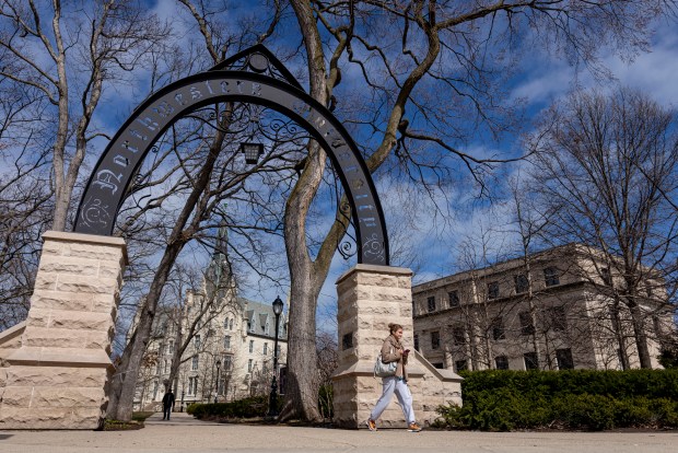People walk by Weber Arch at the corner of Sheridan Road and Chicago Avenue on the Northwestern University campus on March 31, 2025, in Evanston. (Brian Cassella/Chicago Tribune)