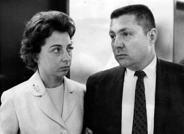 Earle T. Cook and wife Jeanne in the Federal Building on Feb. 5, 1968, as they await a decision from the jury on government charges that Cook placed a bomb in her luggage before her flight in an attempt to kill her. (William Yates/Chicago Tribune)