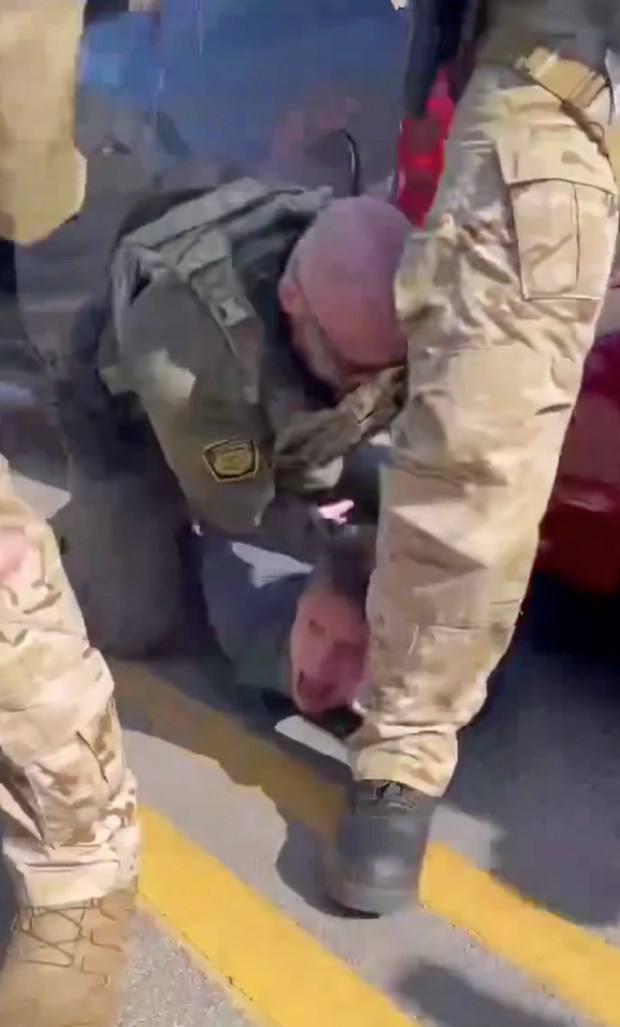 Near Oakton Street and Asbury Avenue in Evanston immigration agents had a standoff with members of the community. A federal agent kneels on a man's back apparently punching him on the side of the head while residents shout, "He can't breathe!" The man was apparently detained after a crash with officers, Oct. 31, 2025. (Provided video)