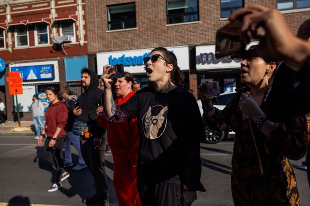 Members of the community yell at U.S. Border Patrol officers while they detain a person in the Albany Park neighborhood on Oct. 31, 2025, in Chicago. (Armando L. Sanchez/Chicago Tribune)