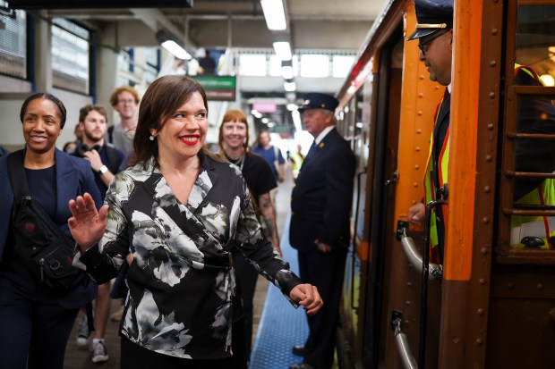 Nora Leerhsen, the CTA's acting president, walks alongside a 1920s-era 4000-series railcar in the Loop on Oct. 1, 2025, where the CTA celebrated their 78th anniversary with Heritage Fleet Program rides for customers. (Eileen T. Meslar/Chicago Tribune)