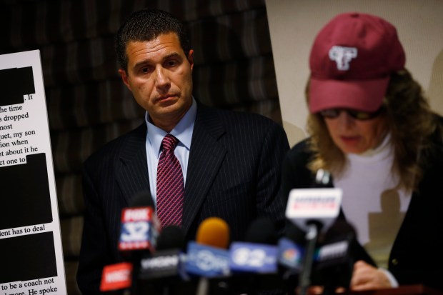 Lawyer Tony Romanucci, left, listens on Nov. 28, 2012, while an anonymous mother describes allegations of abuse against her son at Maine West High School in 2008. (Brian Cassella/Chicago Tribune)