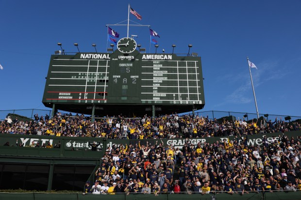 Fans in the bleachers watch an unsuccessful Michigan field goal attempt to end the first half against Northwestern at Wrigley Field on Nov. 15, 2025, in Chicago. (John J. Kim/Chicago Tribune)