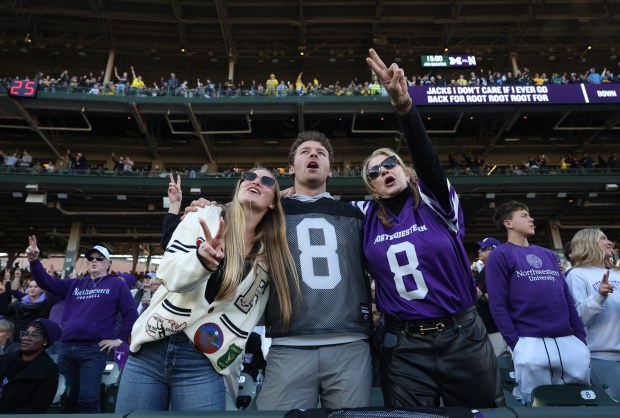 Fans sing "Take Me Out to the Ball Game" at the start of the fourth quarter between Northwestern and Michigan at Wrigley Field on Nov. 15, 2025, in Chicago. (John J. Kim/Chicago Tribune)