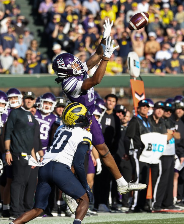 Northwestern wide receiver Hayden Eligon II (80) rises for a first-down reception in the fourth quarter against Michigan at Wrigley Field on Nov. 15, 2025, in Chicago. (John J. Kim/Chicago Tribune)