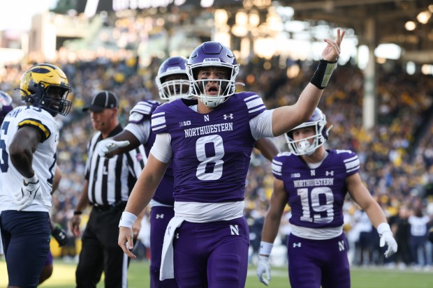 Northwestern quarterback Preston Stone (8) celebrates after a touchdown run in the fourth quarter against Michigan at Wrigley Field on Nov. 15, 2025, in Chicago. (John J. Kim/Chicago Tribune)